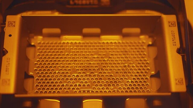 Details of 3D printer manufacturing partial denture. Modern advanced technology device in dental laboratory. Orthodontic applications production. Close-up.