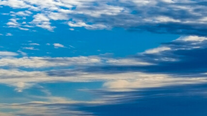 Naklejka na ściany i meble 4K bluish white clouds stretched across a morning sky