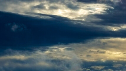 4K Bluish gray skies with sunlight peaking behind