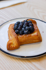 Blueberry danish on blue and white plate