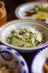 Zucchini strips with pine nuts and cheese