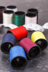 Accessories for using in sewing. Spools of colorful thread and centimeter