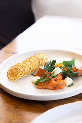 Blini with smoked salmon, cream and herbs
