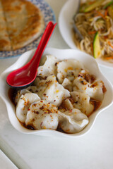 Steamed dumplings in chilli oil