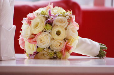 a wedding bridal bouquet on a table of flowers