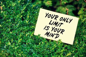 Motivational quote your only limit is your mind written on paper in a garden with green plants in nature. Achievement and accomplishment in life or business.