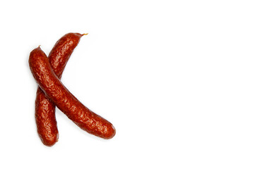 Creative layout of pinkel, a smoked kaszanka sausage, Cabanossi isolated on white background. Food concept. Flat lay and copy space for text