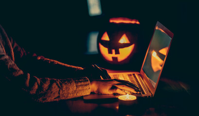 Halloween evening at the computer. Woman talking on the feast of Halloween on the internet....