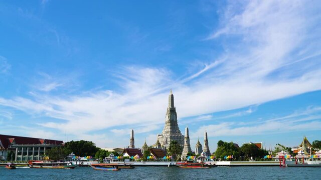 Wat arun temple of dawn with Chao Pra Ya river sunshine day wooden boat sightseeing in Bangkok Thailand