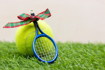 Tennis Christmas with tennis ball and racket on green grass