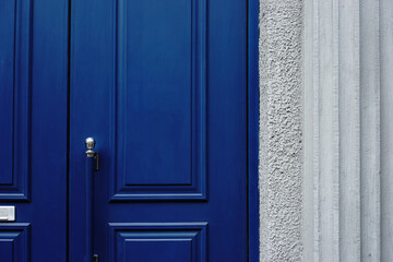 Blue wooden door with moldings.