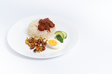 Nasi Lemak-Malaysian cuisine. A fragrant rice dish cooked in coconut milk and pandan leaf commonly found in Malaysia. A white background provides copy space to the