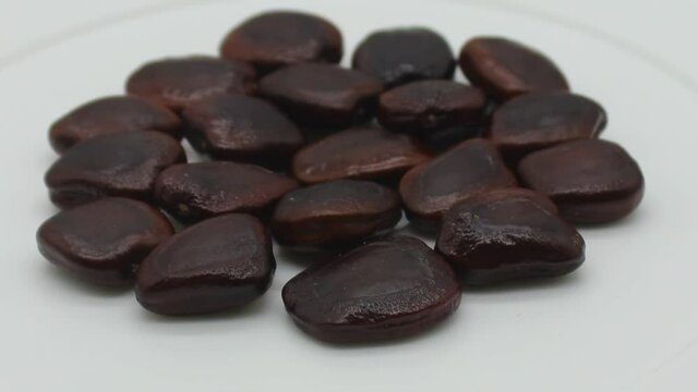 Tamarind seeds on white background