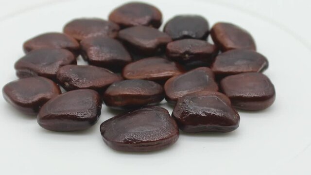 Tamarind seeds on white background