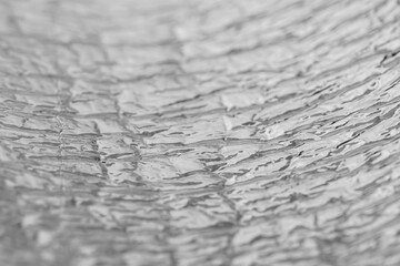Crumpled aluminum foil texture. Shallow depth of field.