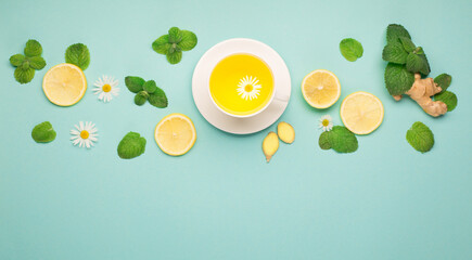 Lemon and ginger tea with honey on paper background.