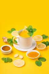 Lemon and ginger tea with honey on paper background.