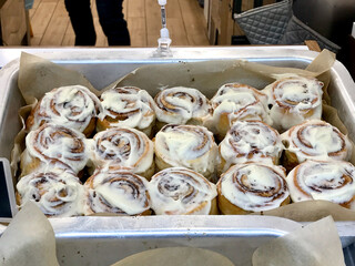 Cinnamon Buns in Glaze for Sale at Showcase of Dessert Shop / Cinnabon in Tray.