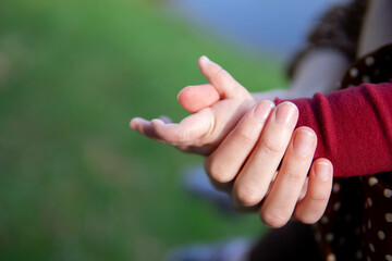 mother's hand holds baby's hand. mother and child composition