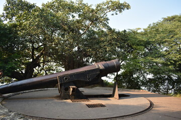 A cannon from historical era situated on top of a cannon hill