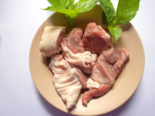 raw meat and vegetables on a plate