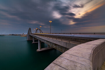 Fototapeta na wymiar Hidd Bridge, Manama, Bahrain. Long exposure morning view from the side of the bridge