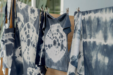 Fabric dyeing with natural colors. batik tie dyed fabric of indigo color on white cotton.