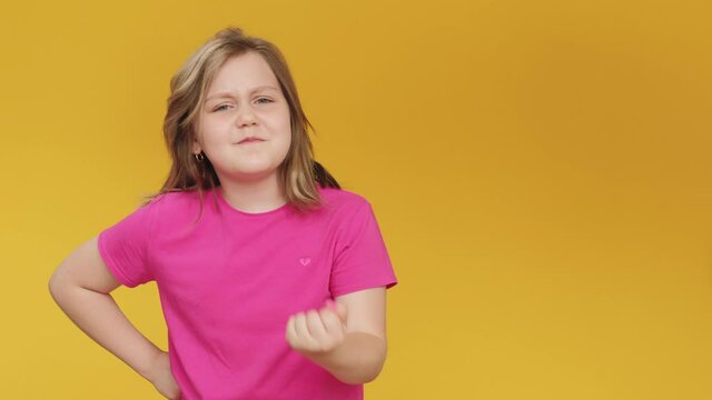 Annoyed kid. Facepalm gesture. Mistake disappointment. Angry displeased cute young chubby girl in pink t-shirt shocked with failure questioning how isolated on yellow copy space background.
