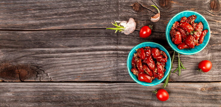 sandwich with goat cheese, sun-dried tomatoes and garlic, oregano, olive oil wooden textured background. space for text. top view. Long banner format