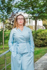 Portrait of American plus size businesswoman in light blue suit, citizen lifestyle, concept of women's life