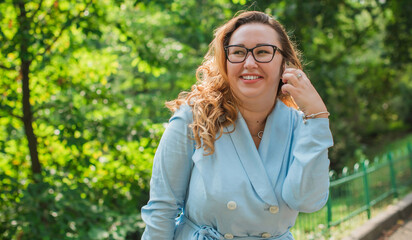 Portrait of American plus size businesswoman in light blue suit, citizen lifestyle, concept of women's life