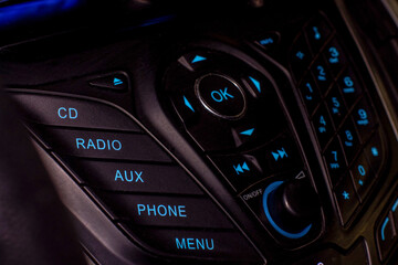 Radio and telephone control in the car. Luminous buttons.