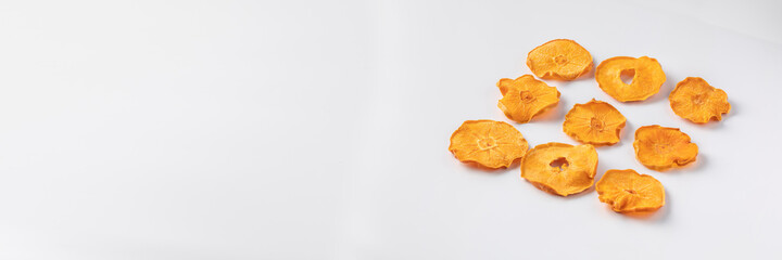 Naklejka na ściany i meble slices of dried persimmon on a white background. dried fruits. eco. top view.