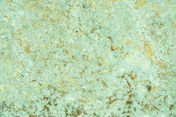 concrete aged texture. old, vintage celadon green background. gold with roughness and cracks