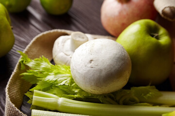 Champignons and fresh fruits and vegetables on wooden table, closeup, selective focus