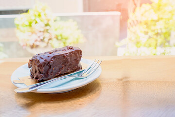 Chocolate browine cake on white plate. Copy space.