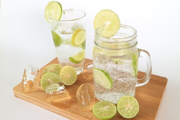 Health care, fitness, healthy nutrition diet concept. Fresh cool lemon infused water, detox drink, lemonade in a glass jug and a glass.