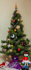 Christmas artificial tree decorated with toys