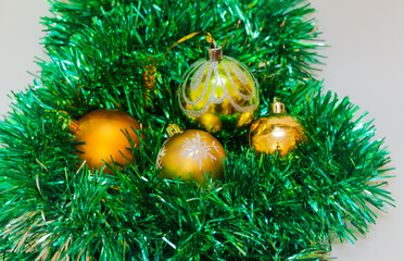 Golden Christmas balls with green tinsel