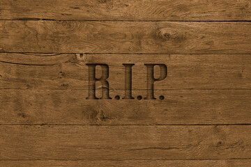 Wooden board with word rip carved in it