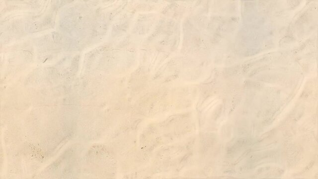 top view clear water wave surface on white sand in seamless loop repeat