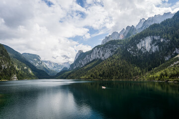 Fototapeta na wymiar A boat on Lake Gosau with view to Dachstein