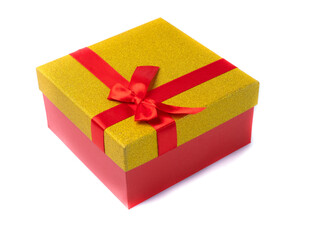 Gift box gold color with a red bow on a white background. Isolated.