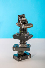 Pyramid from old film cameras on a colored background