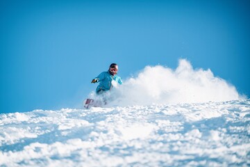 Naklejka na ściany i meble Freeride powder, snowboarding in Les deux alpes resort in winter, mountains in French alps, Rhone Alpes in France