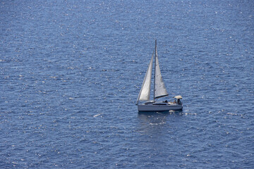 Obraz premium Small Sailing boat yacht in the open blue Sea
