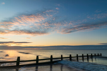Fototapeta na wymiar Stunning colorful sunrise over beach landscape on English South coast