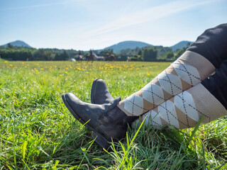 Woman horse rider sit with crossed legs in paddock