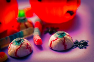 Fototapeta premium halloween candies seen close up on lilac background