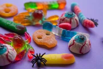 halloween candies seen close up on lilac background